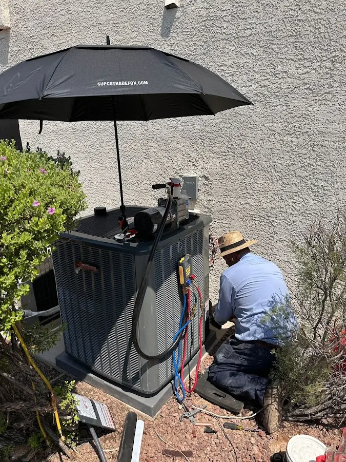 HVAC technician performing outdoor AC maintenance in Upper Allen
