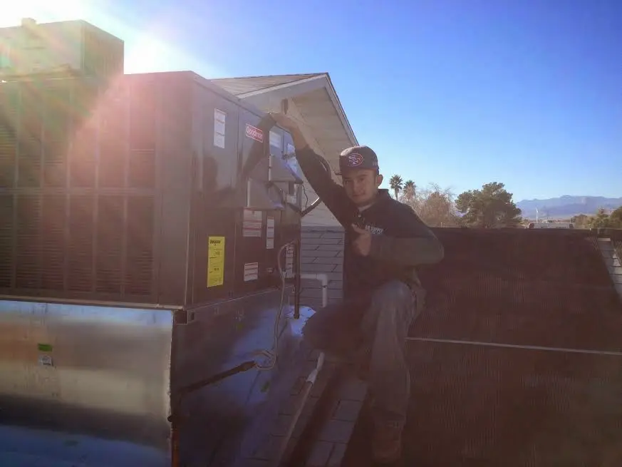 HVAC technician performing Boiler Repair on a rooftop unit in Upper Allen